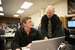 College Professor in classroom with student