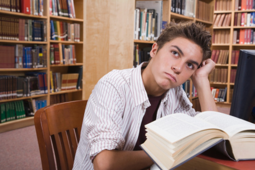 high school junior studying in library