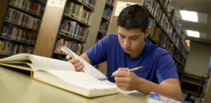 freshman studying at the library