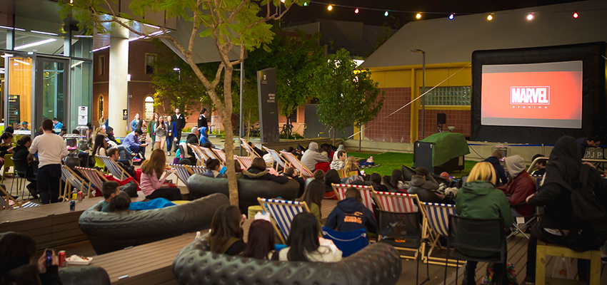 students watching movie on campus