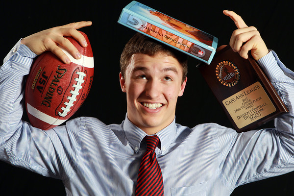 student with books and a football ball
