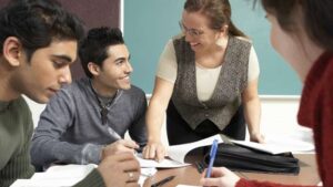 teacher helping college students