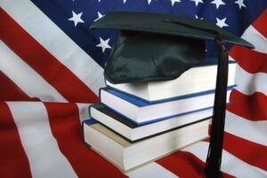 US flag, book, and graduate hat